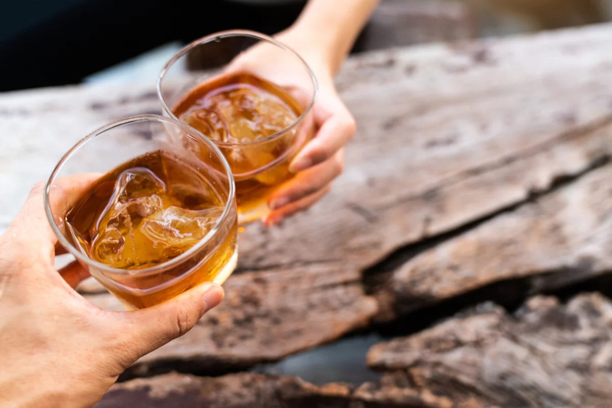 Two rye whiskey cocktail drinks toasted together