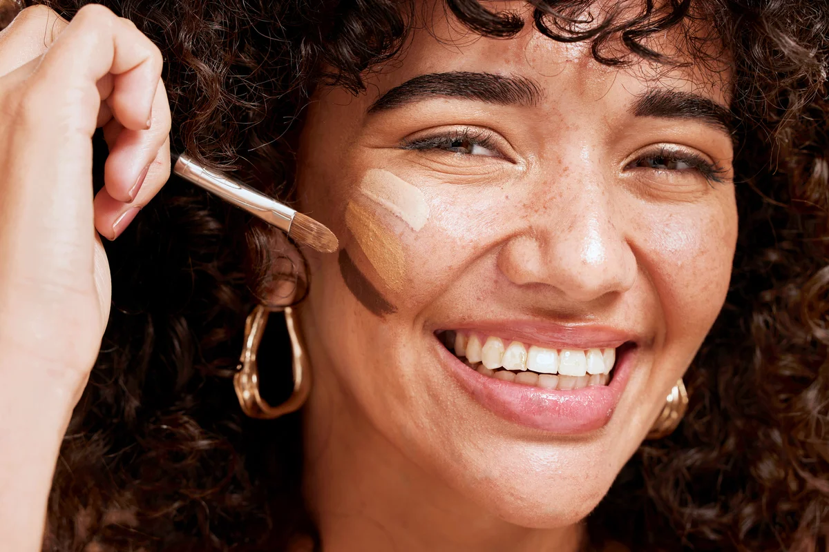 Woman applying foundation to her skin